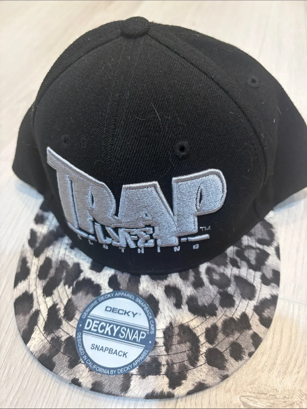 TRAP Life Embroidered Snapback Hat with Leopard Brim